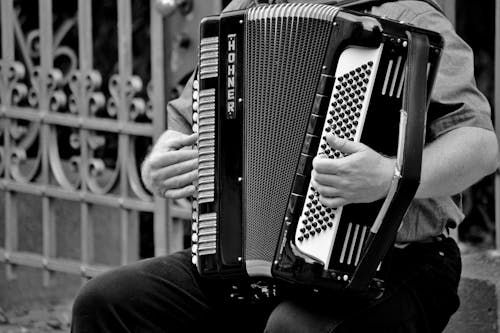 Person Playing a Horner Musical Intrument in Grayscale