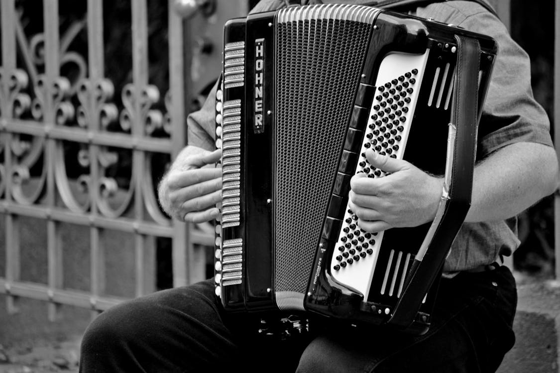 Free Person Playing a Horner Musical Intrument in Grayscale Stock Photo