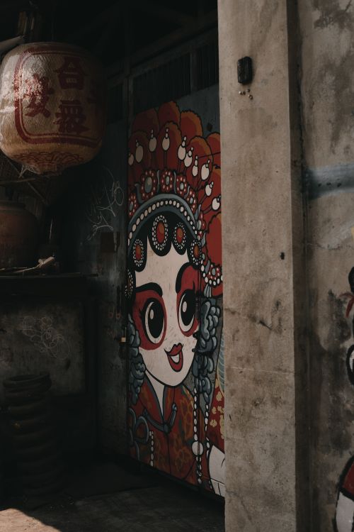 Free Vibrant graffiti of a cartoon character on a city street door in Bangkok, Thailand. Stock Photo
