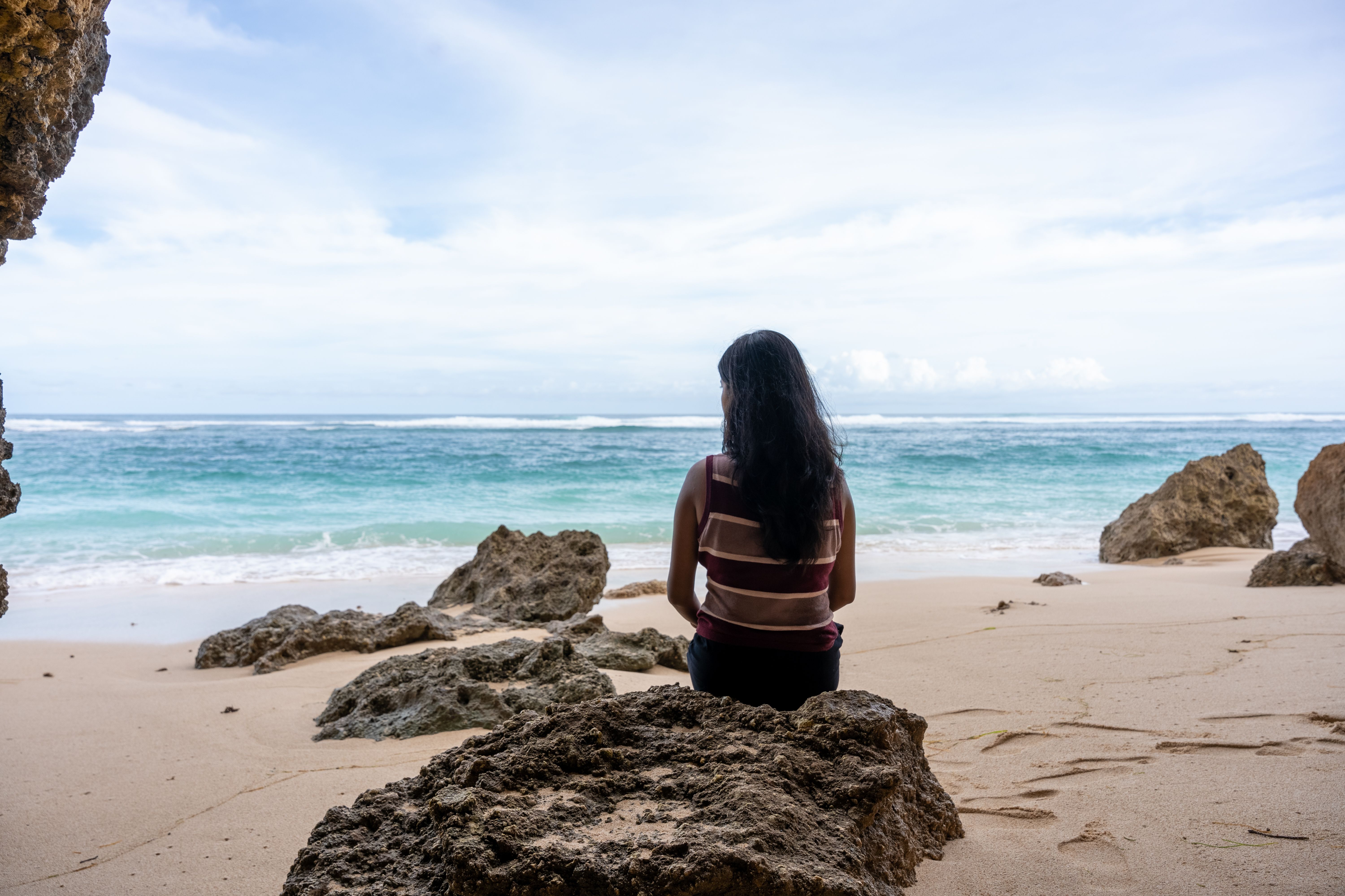 Woman Sitting on Sea Shore · Free Stock Photo
