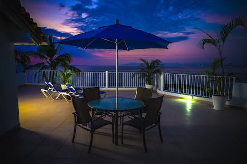 Round Metal Patio Near Railings at Night