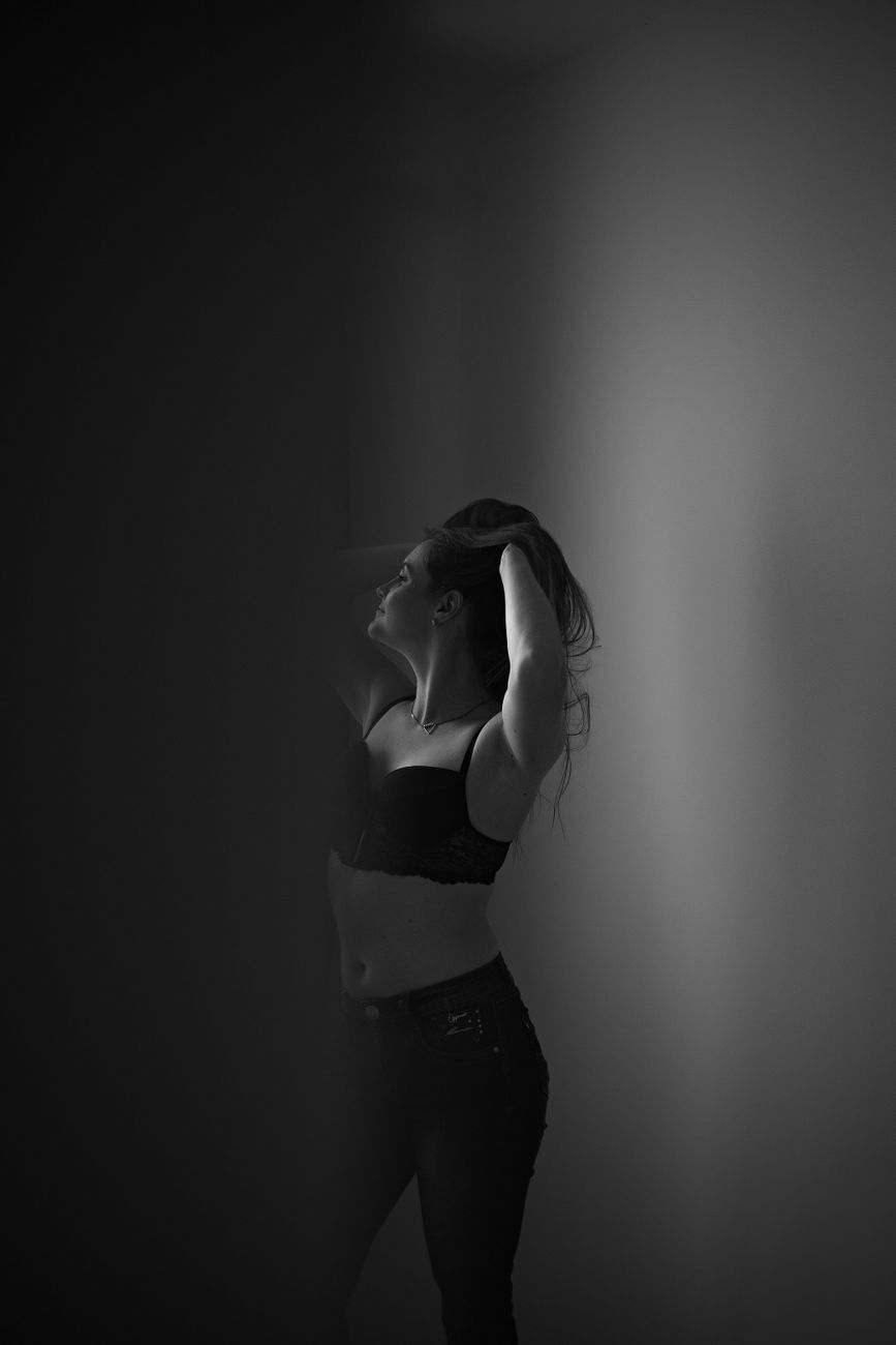 Elegant black and white portrait of a woman posing with confidence.