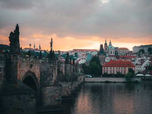 Free Stunning view of Charles Bridge and Prague cityscape during sunset, featuring historic architecture. Stock Photo