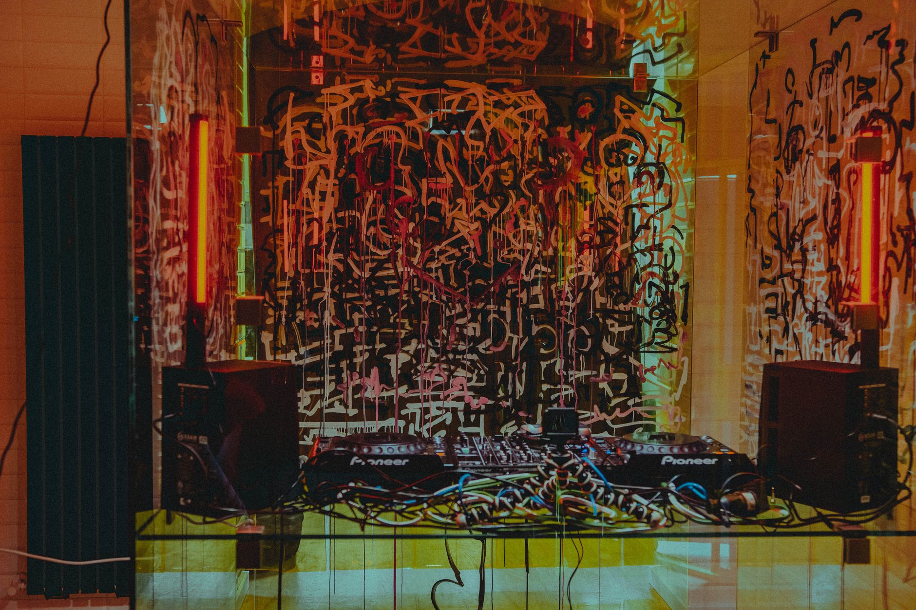 Dynamic DJ setup with colorful graffiti backdrop in Lwiw, Ukraine. Perfect for music and urban art themes.