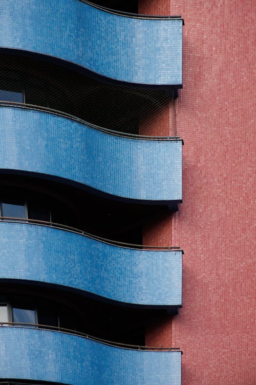 Blue Balconies on Red Apartment Building in Curitiba, Brazil