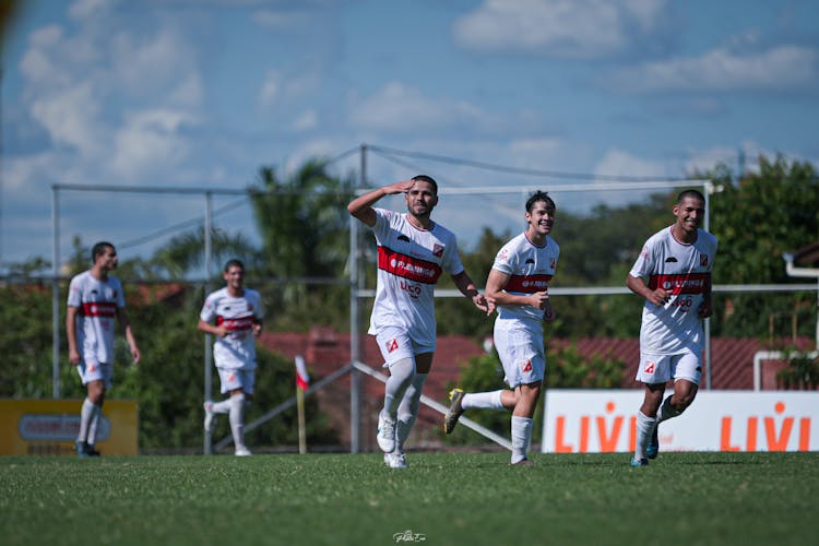 Football Players Celebrating On Match