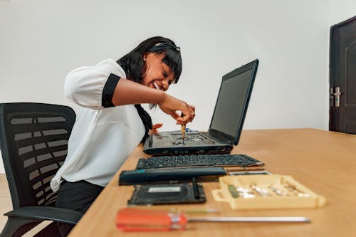 A Woman Repairing Laptop