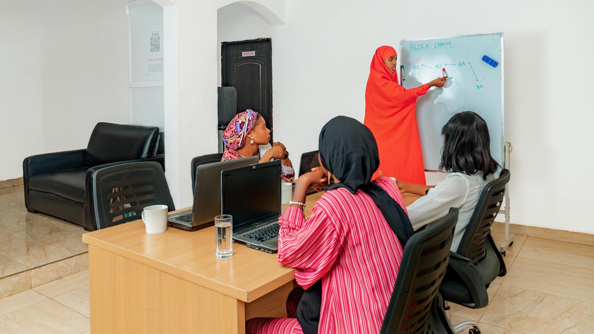 Group of women attending a technology class with a focus on blockchain.