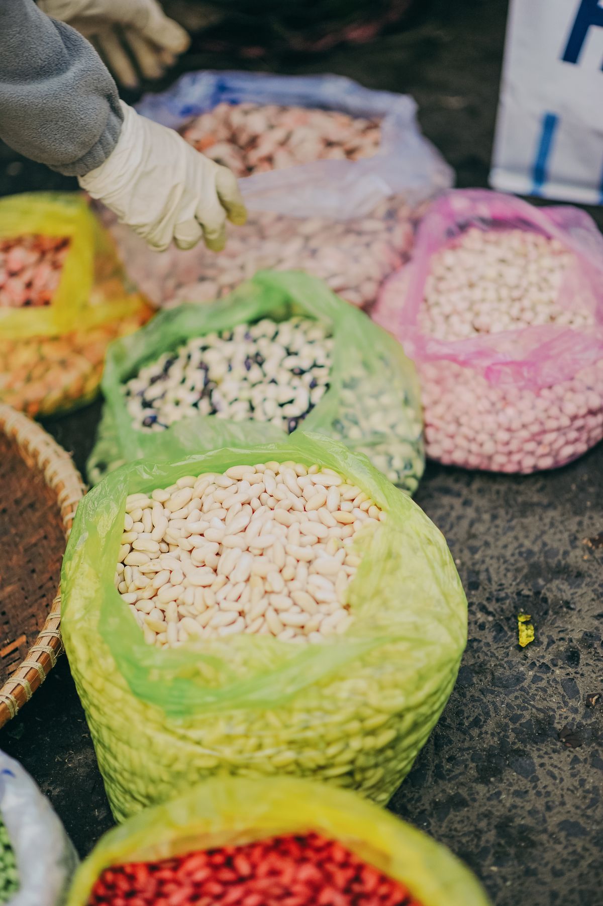 Sacks of assorted dried beans, chickpeas and lentils at a market — classic foods that cause bloating