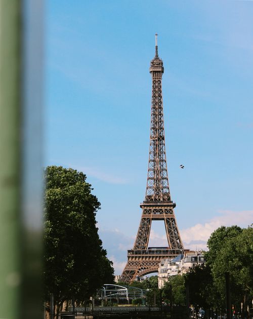 Free Iconic Eiffel Tower in Paris, France, captured on a sunny day with clear skies. Stock Photo