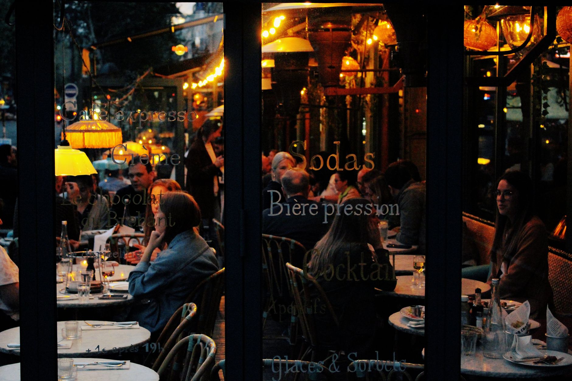 Candlelit Parisian bistro dining room with zinc bar
