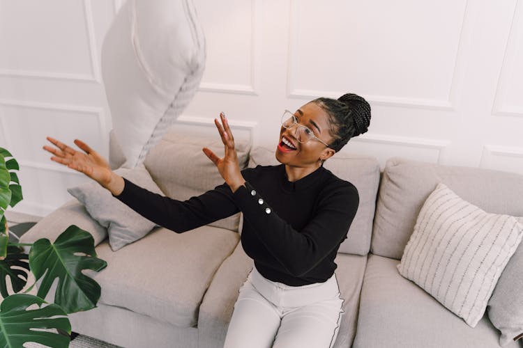 Smiling Woman Throwing Pillow