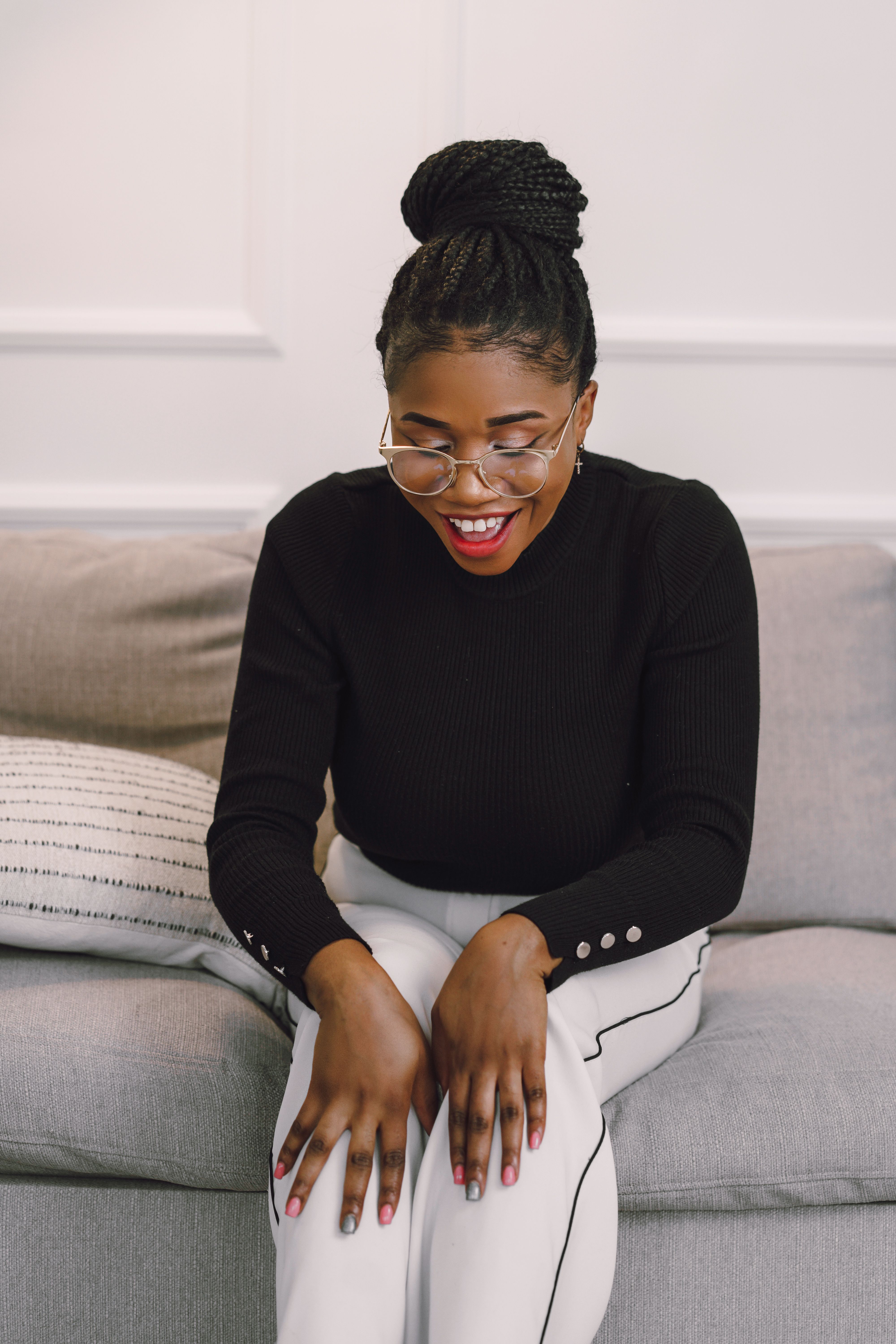 Laughing Woman Sitting on a Couch · Free Stock Photo