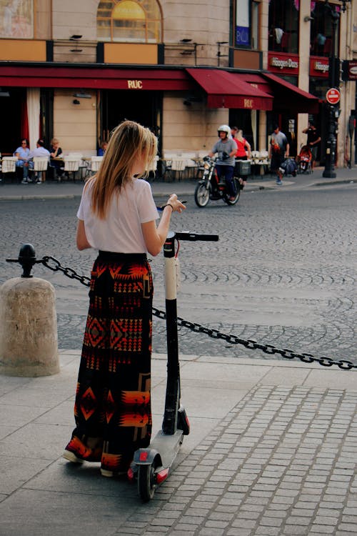 Blonde Woman with Electric Scooter