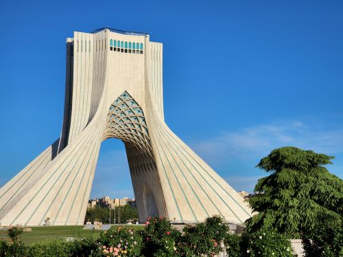 Free Azadi Tower, a prominent architectural landmark in Tehran, Iran, captured on a sunny day. Stock Photo