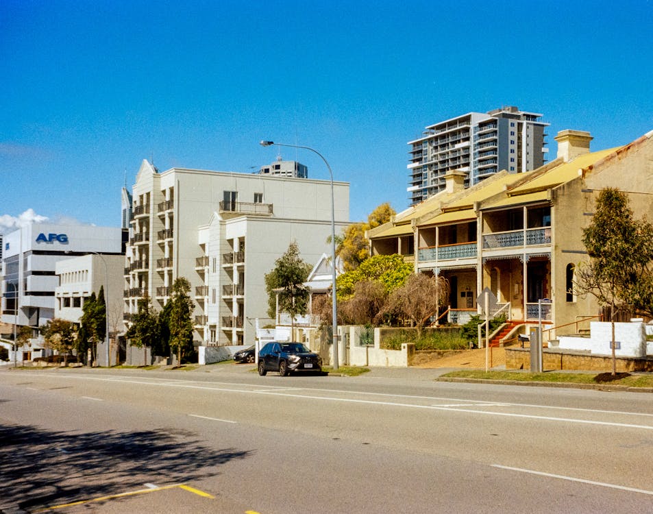 A street in Auckland with a mix of modern apartments and older houses