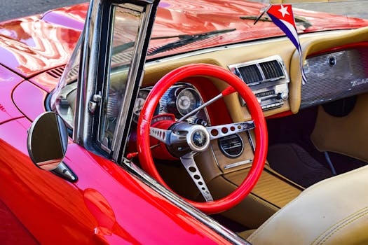 Close-up of a classic red convertible interior with Cuban flag in Havana, Cuba.