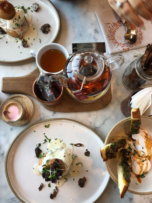 Free Overhead view of a sophisticated breakfast table with tea and gourmet dishes. Stock Photo