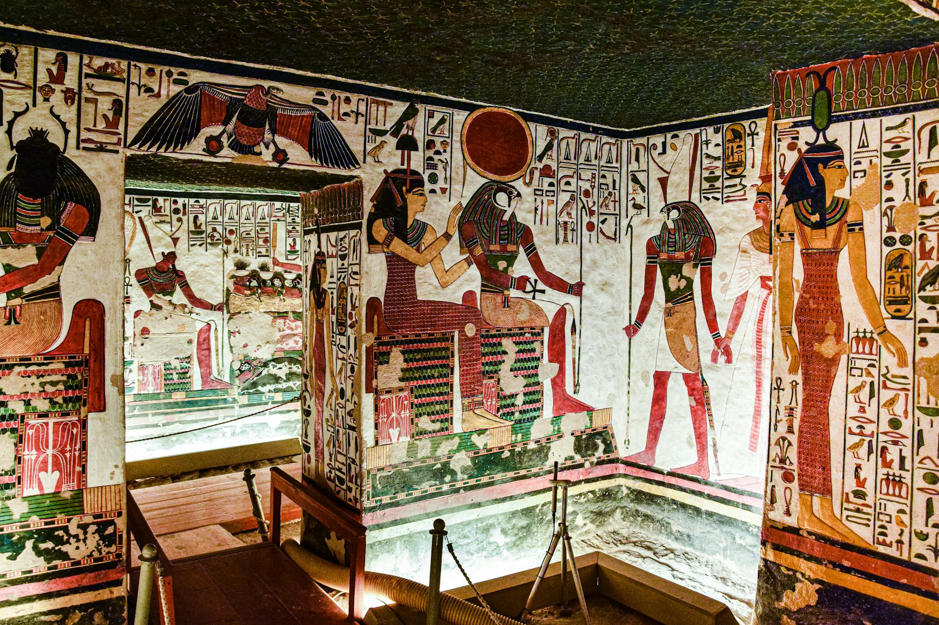 Colorful murals inside an Egyptian tomb in Luxor, showcasing historical art.