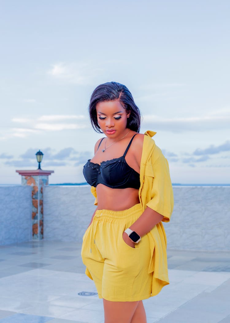 Woman Standing On Terrace In Black Bra And Yellow Short