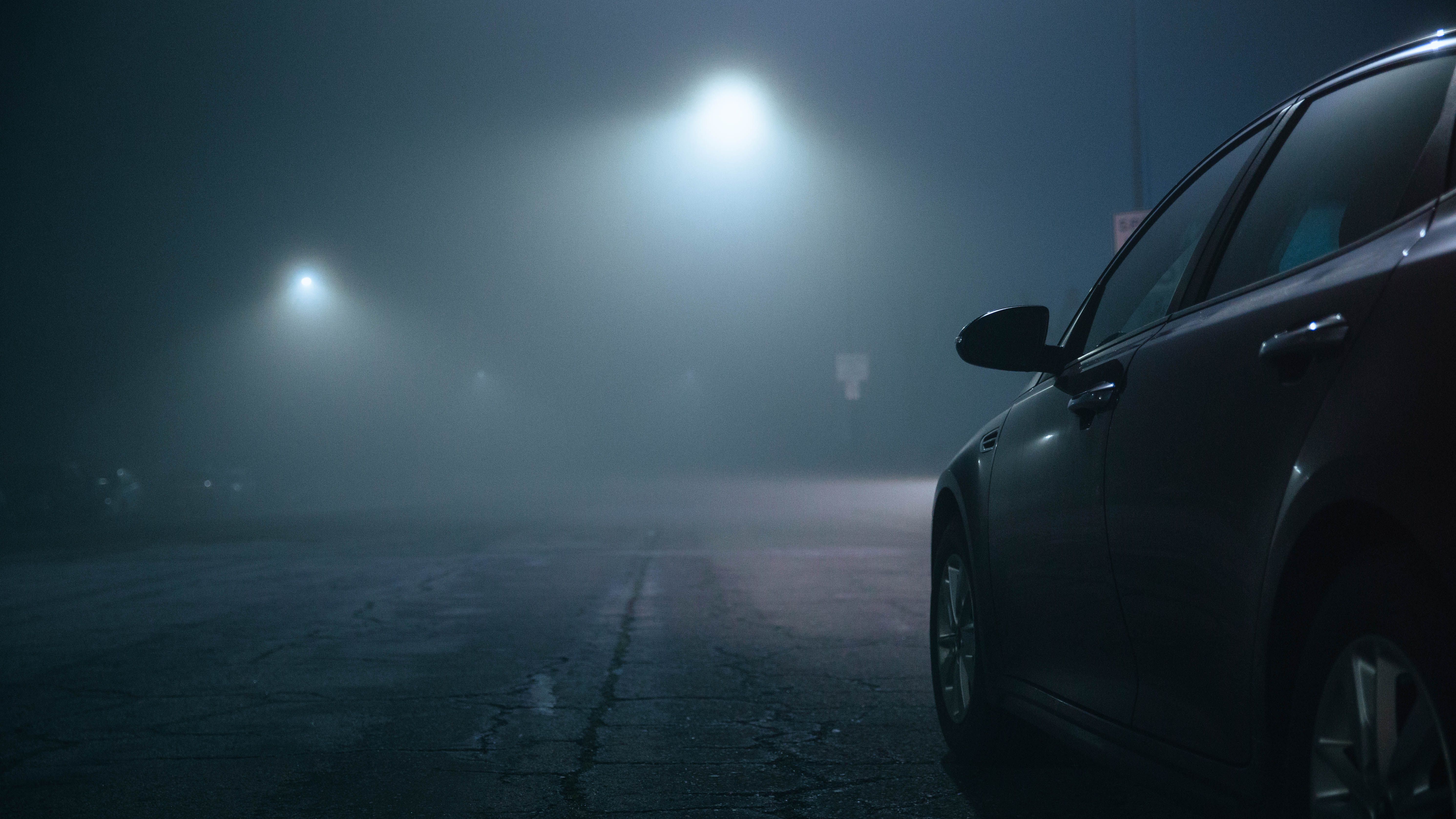 Rainy London street illuminated by street lamps, with a detective’s silhouette fading into fog.