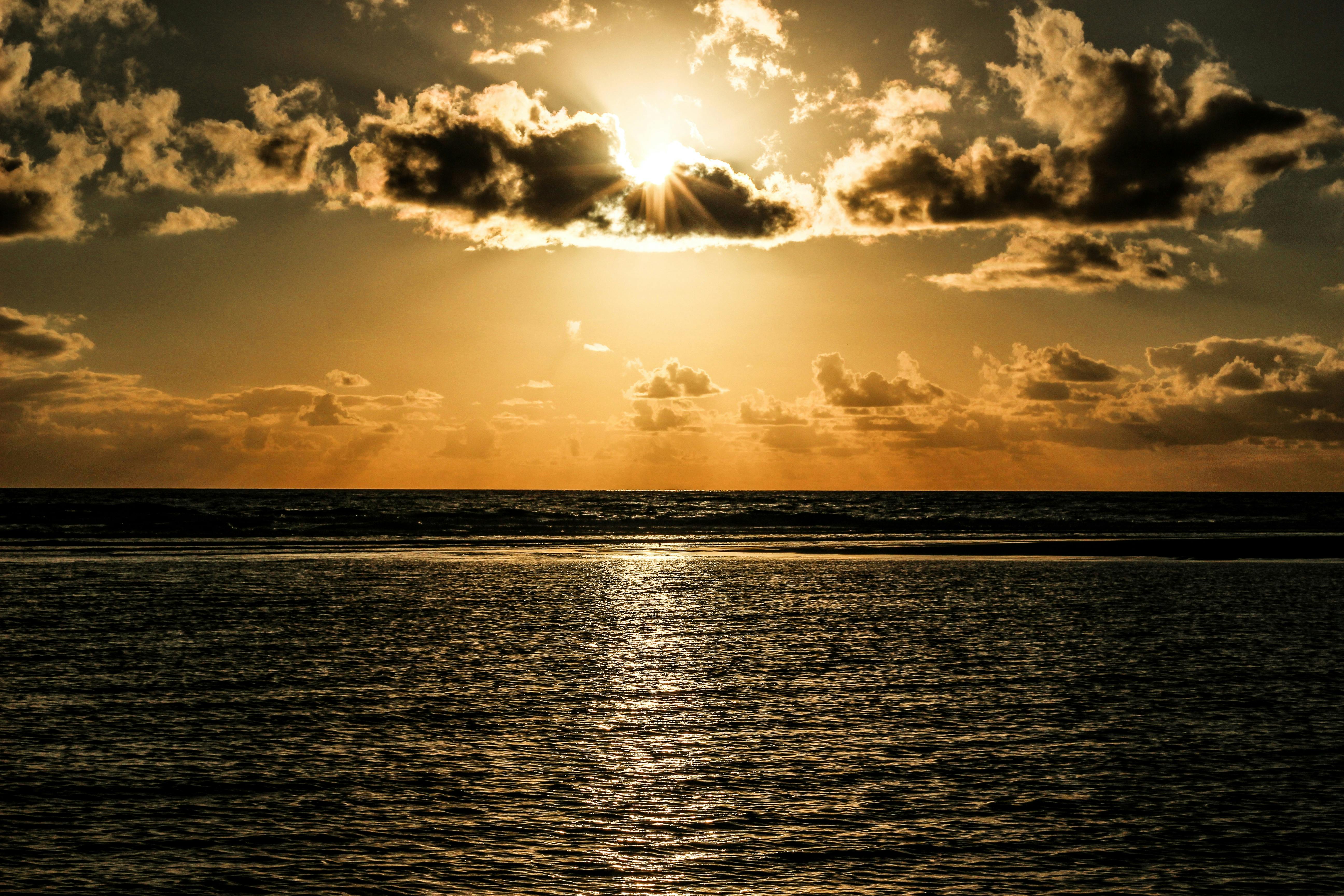 Sun Covered With Clouds Above Sea Free Stock Photo sun-covered-with-clouds-above-sea-free-stock-photo
