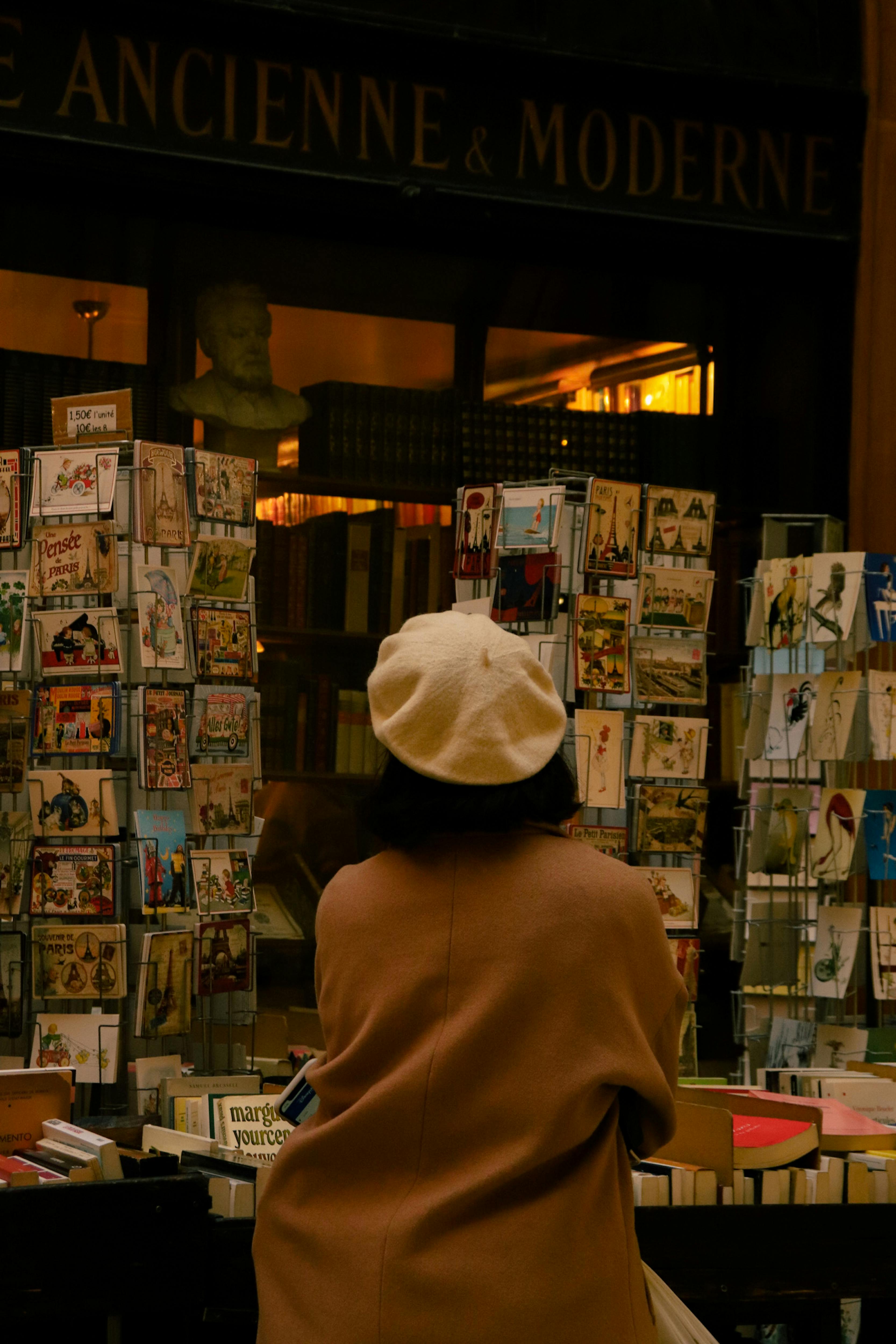 A woman looking at books in a bookstore