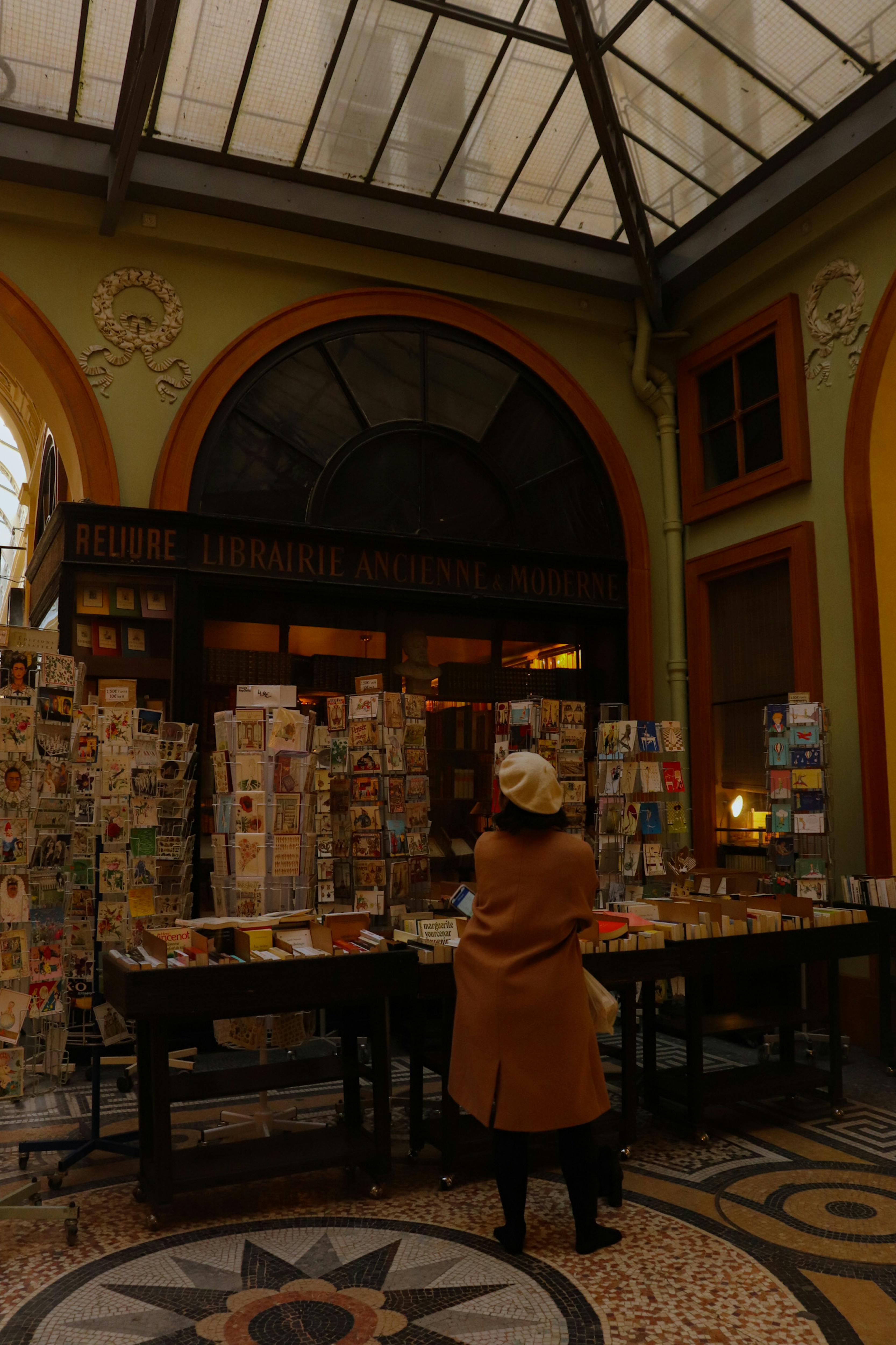 a woman standing in front of a book store