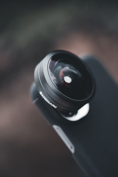Free Detailed close-up of a fisheye lens attachment on a smartphone, showcasing optics technology. Stock Photo