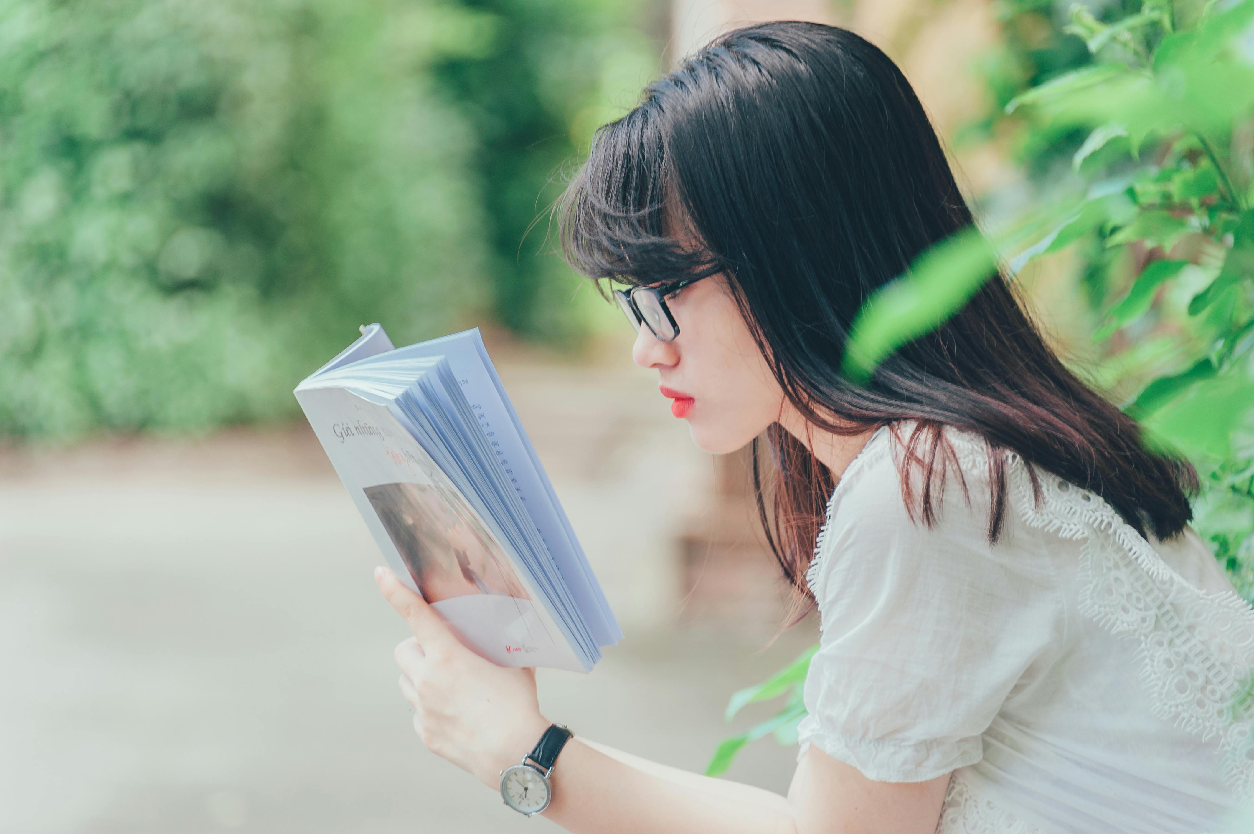 Woman Reading Book Near Bush \u00b7 Free Stock Photo