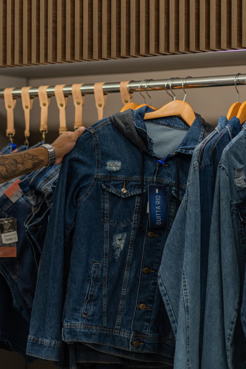 Denim jackets hanging on wooden hangers