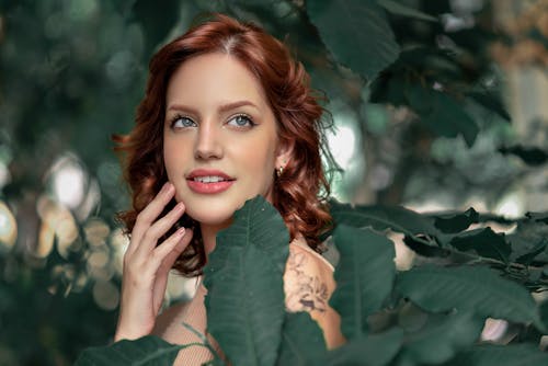 Young Woman Among Green Leaves