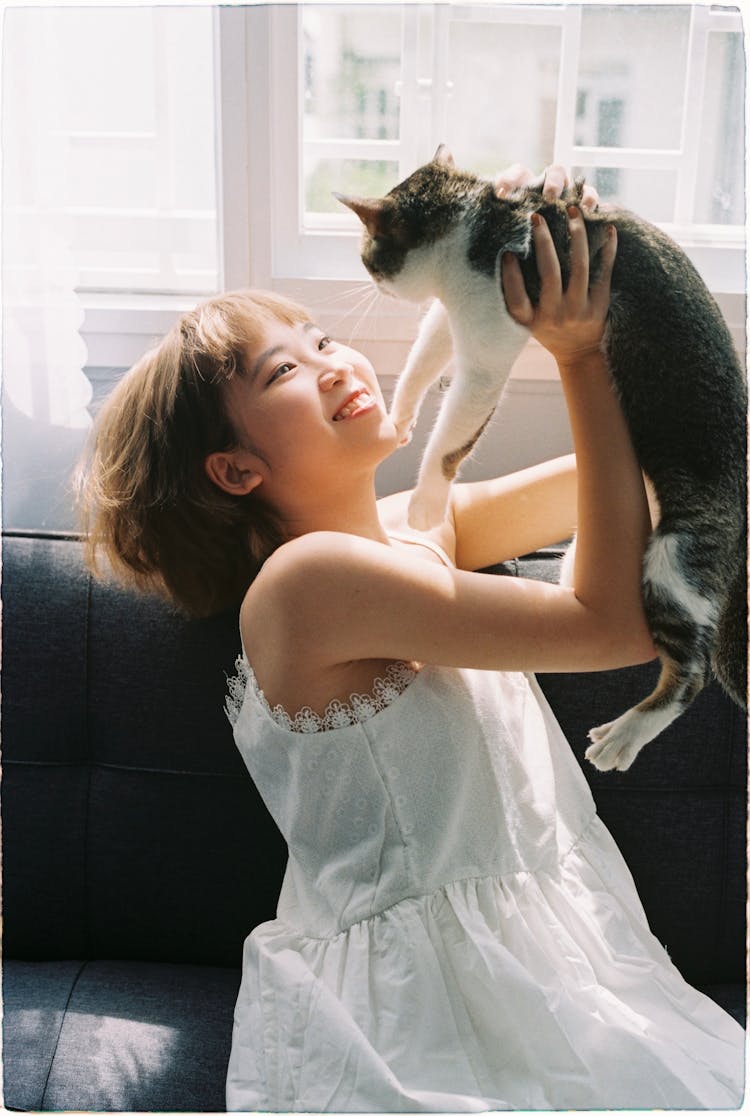 Smiling Girl Playing With Cat