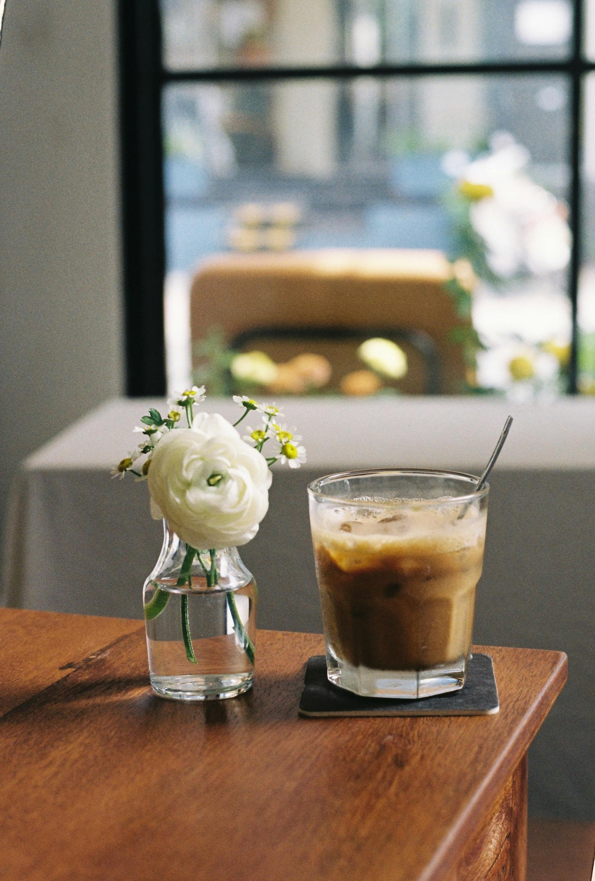 Premium Photo  Iced latte coffee in takeaway glass on table in coffee shop  cafe restaurant