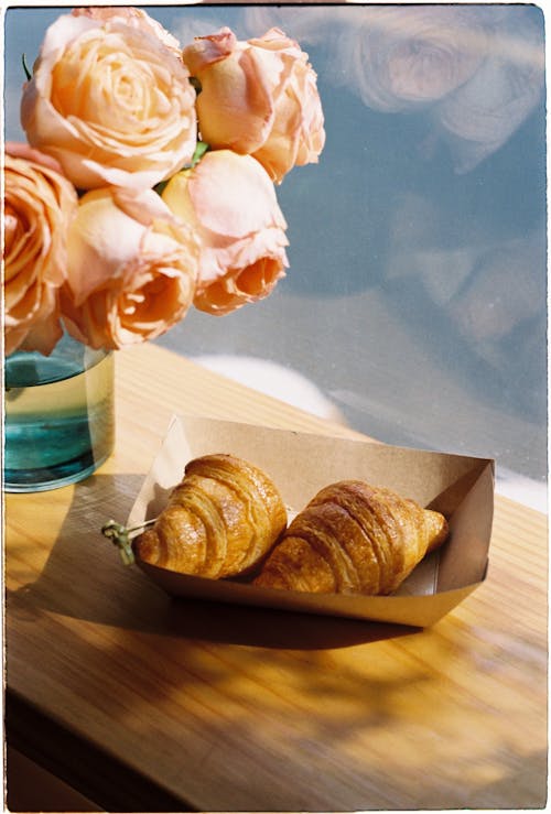 Free Fresh Croissants and Flowers on Table in Cafe Stock Photo