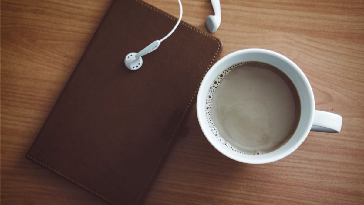 Photo: revac film's&photography / Pexels Coffee, earphones and a notebook on a wooden table