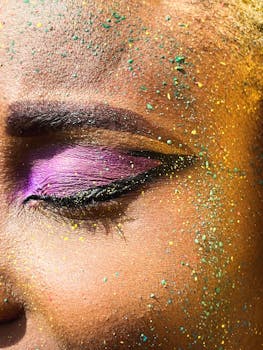 Close-up image showcasing vibrant glitter and makeup artistry on skin.