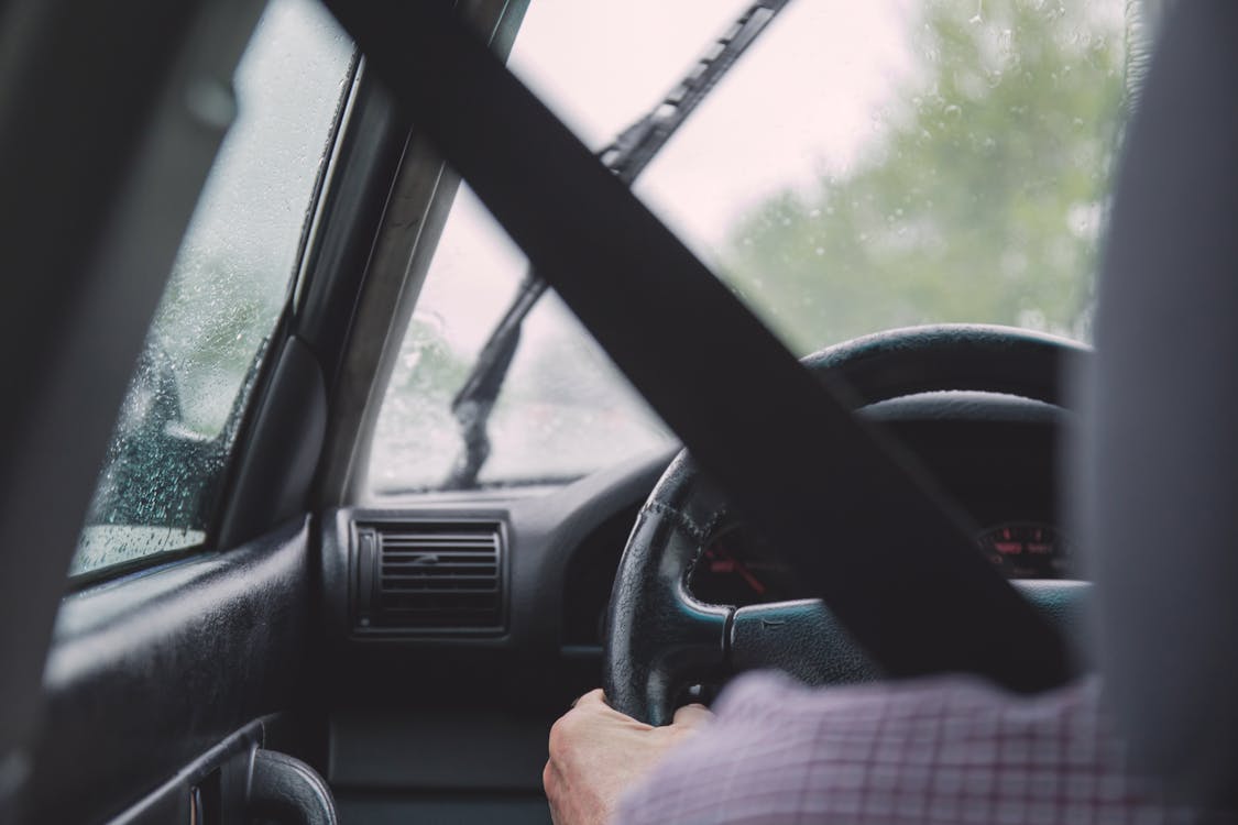 Person Holding Vehicle Steering Wheel Inside Car