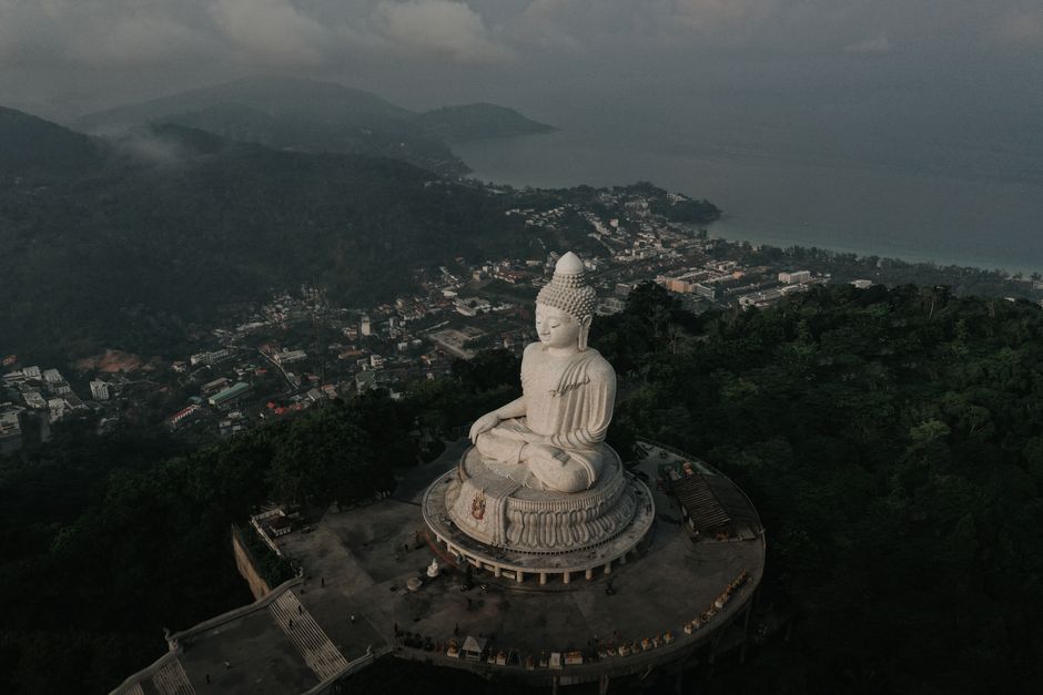 Captivating aerial shot of the iconic Big Buddha statue overlooking Phuket, Thailand's lush landscape.