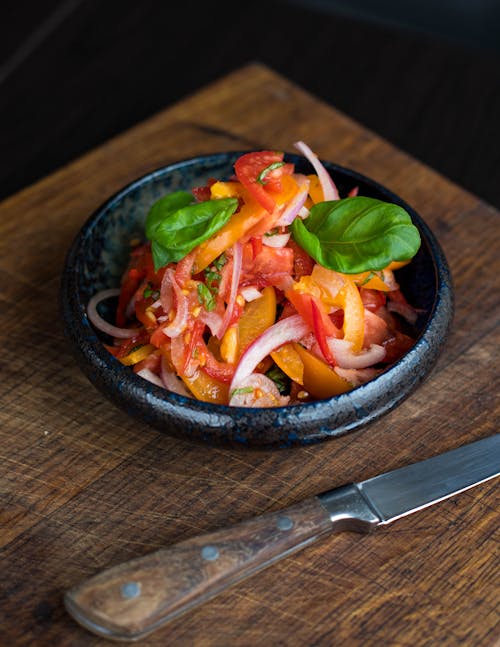 Tomato Salad in Plate Beside Knife