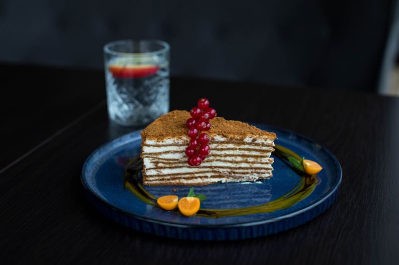 A slice of layered cake on a blue plate