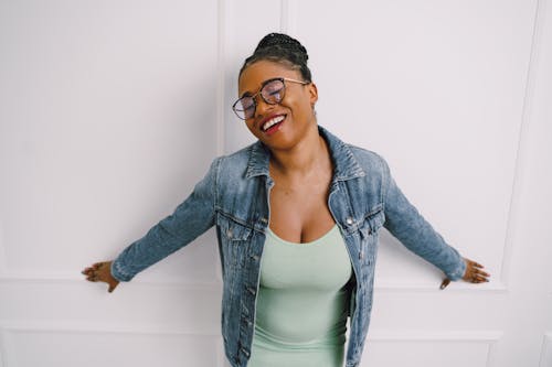 Smiling Woman in Jean Jacket Posing with Eyes Closed