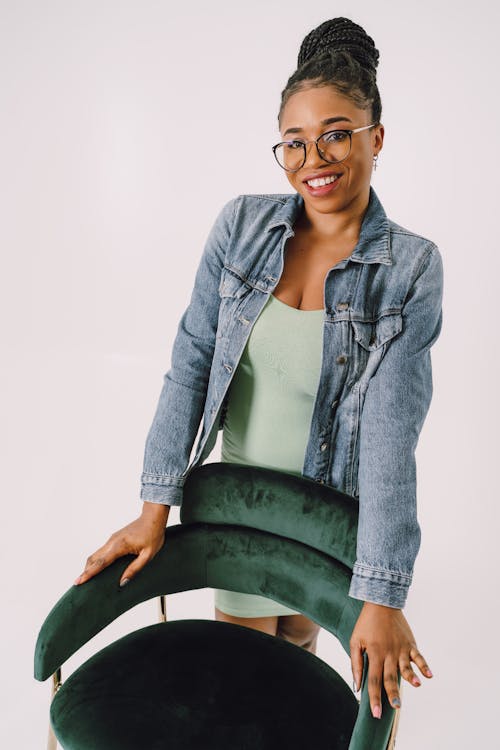 Smiling Woman Posing behind Chair