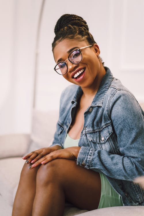 Woman in Jean Jacket Sitting and Smiling