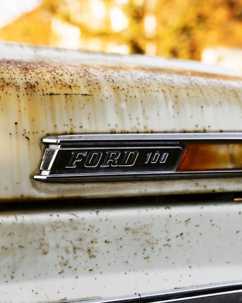 Close-up of the Logo on the Back of a Rusty Vintage Ford 