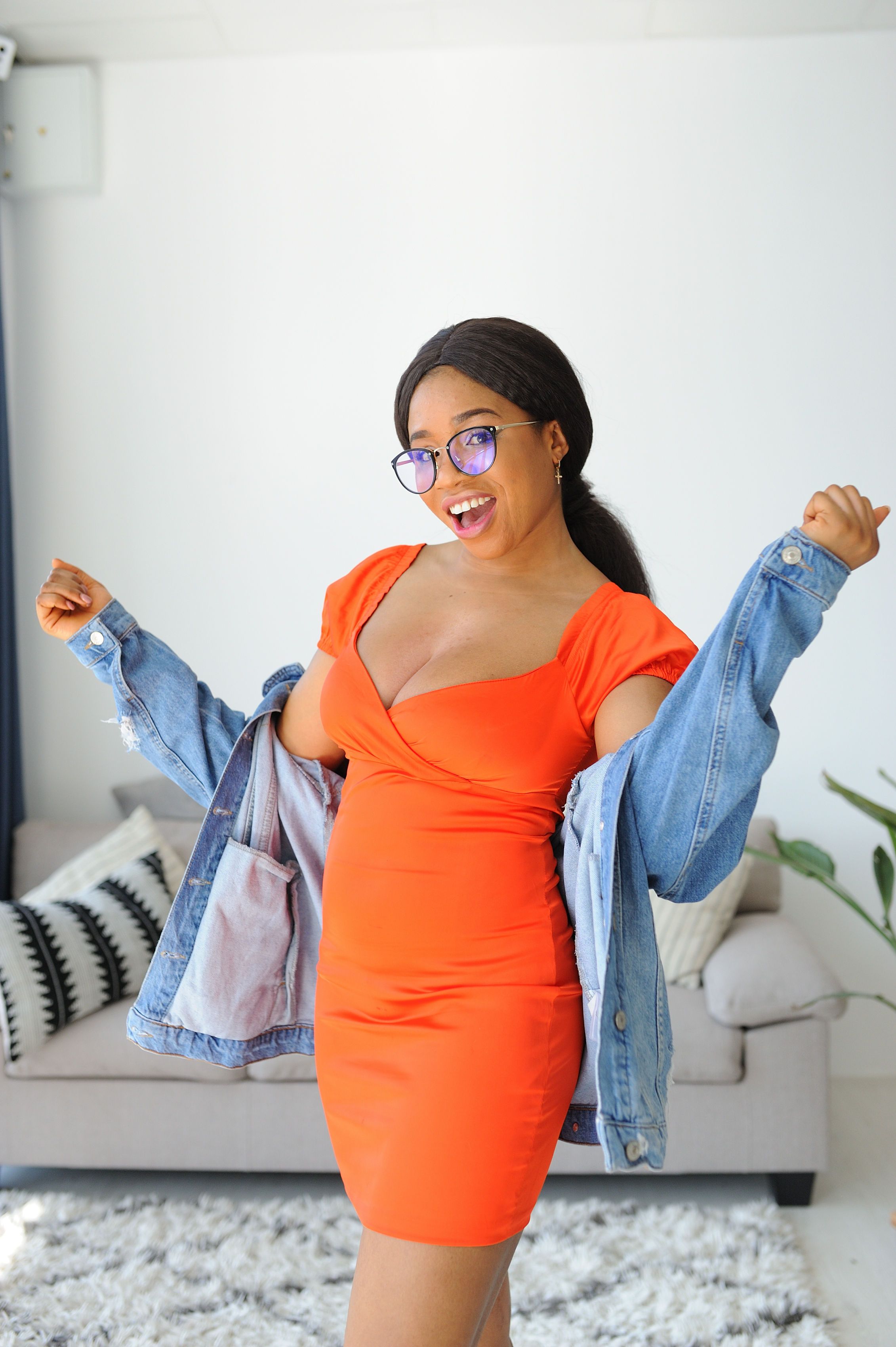 Young Woman Wearing an Orange Dress and a Denim Jacket  Free Stock Photo
