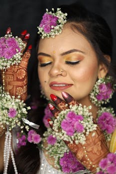 Beautiful Indian bride with floral jewelry, mehndi, and traditional attire, captured in a close-up portrait.