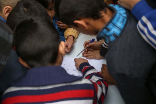 Group of Children Solving a Puzzle