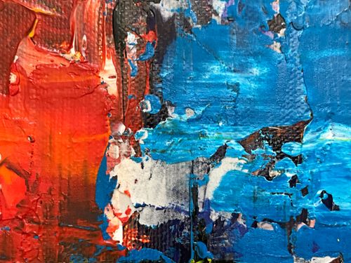 Free A close-up of a vibrant abstract acrylic painting with bold red and blue textures. Stock Photo