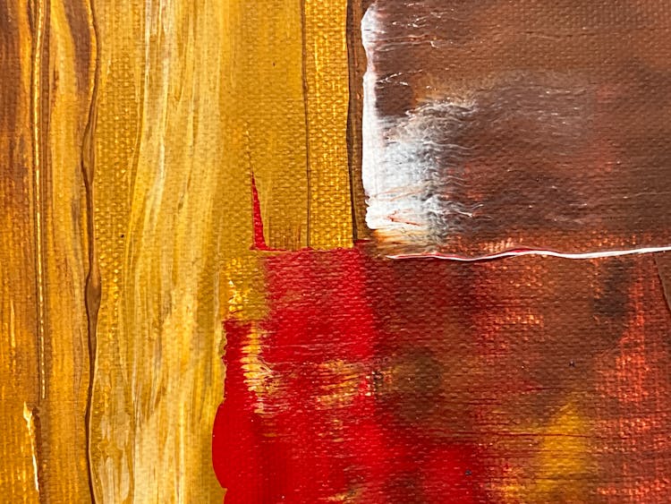 Close-up Of A Red Streak On The Yellow And Brown On An Abstract Painting